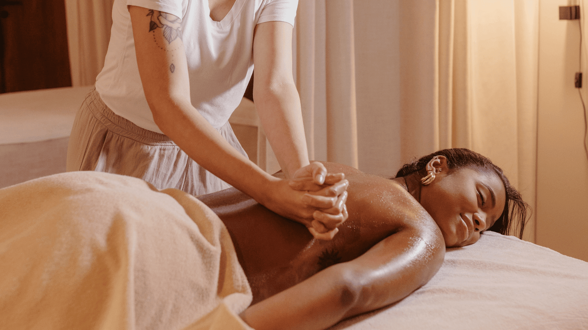 Person receiving a relaxing massage in a calm spa setting.