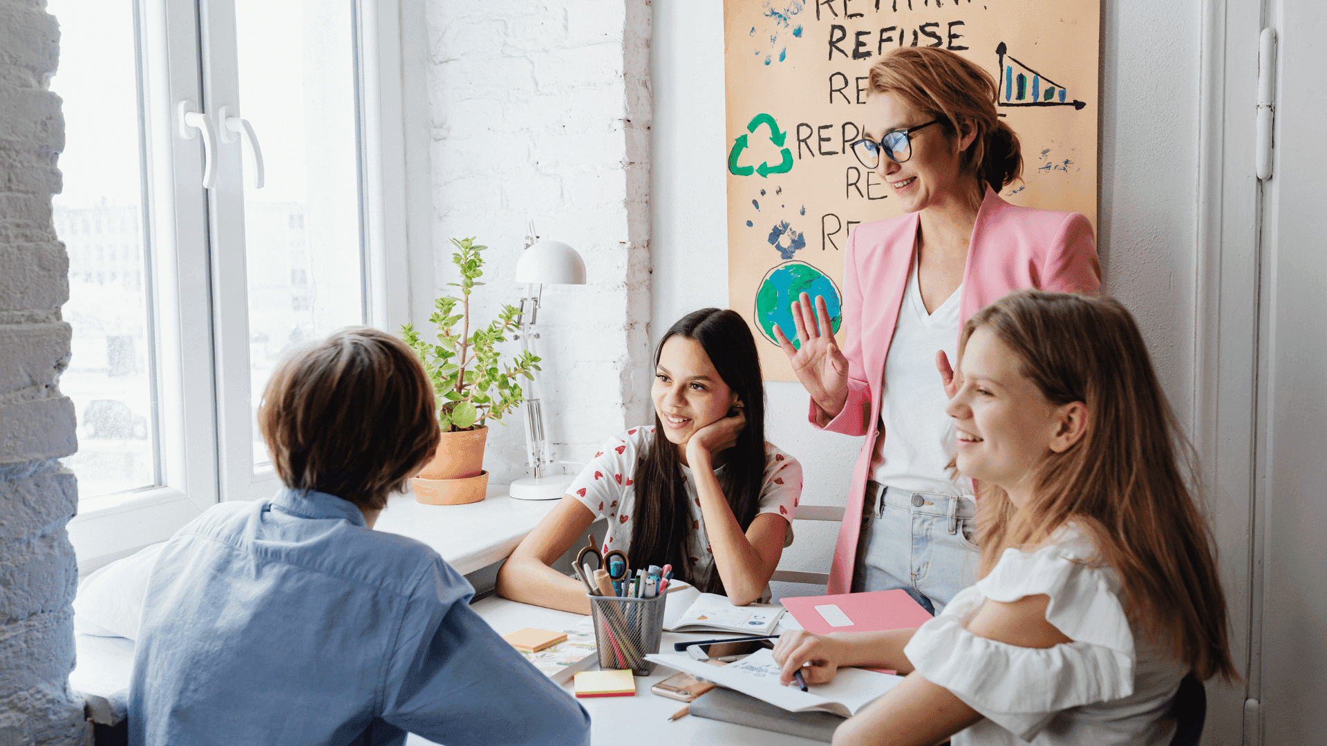 Group discussion in a classroom with engaged teacher and attentive students.